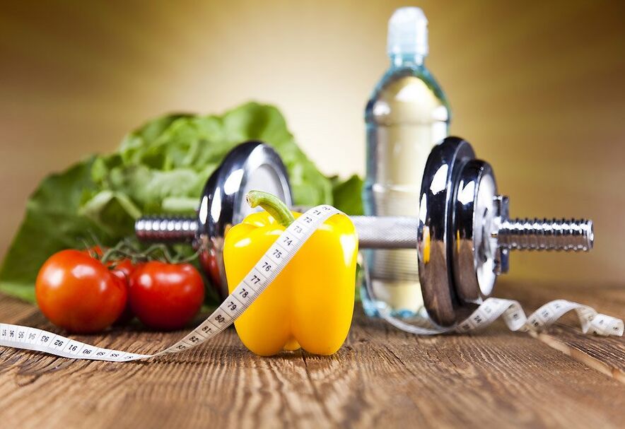 Pesas, verduras e cinta centímetro